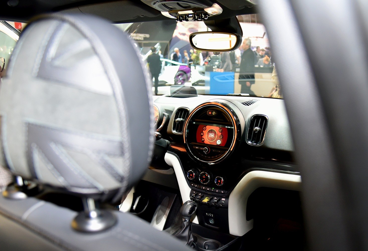 Interior dashboard with circular infotainment display and control panel