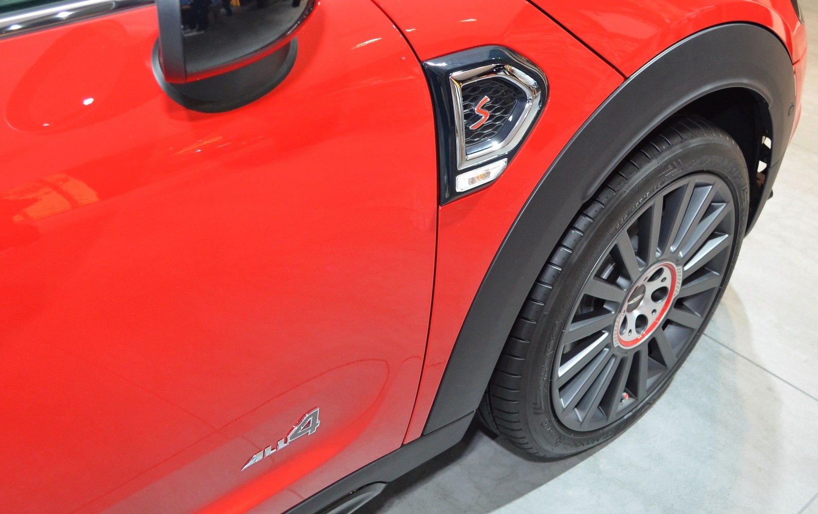 Close-up of red SUV side with 4x4 badge and alloy wheel