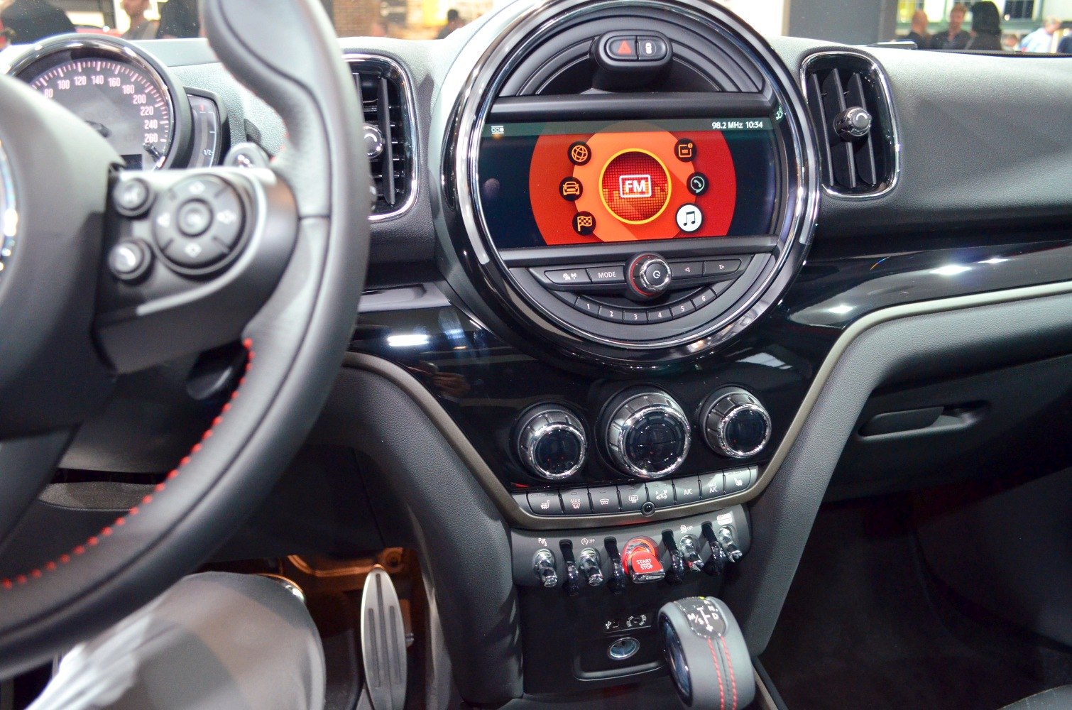 Circular infotainment display and toggle switches on center console