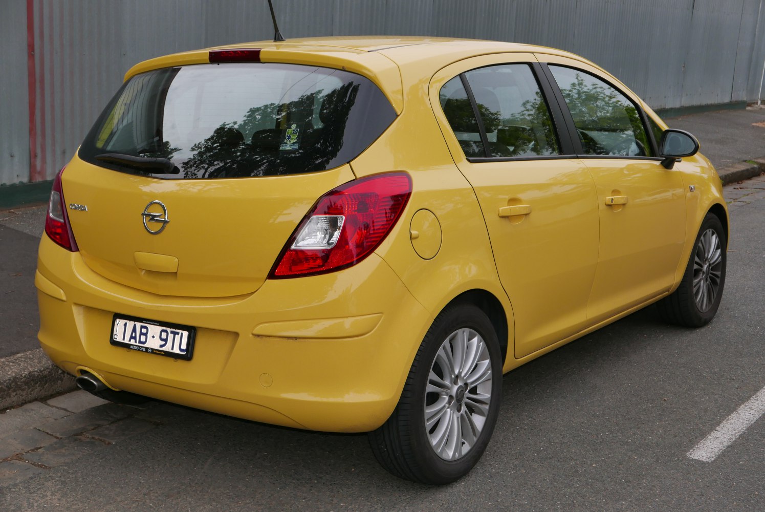 Yellow 5-door hatchback rear and side view with large tail lights