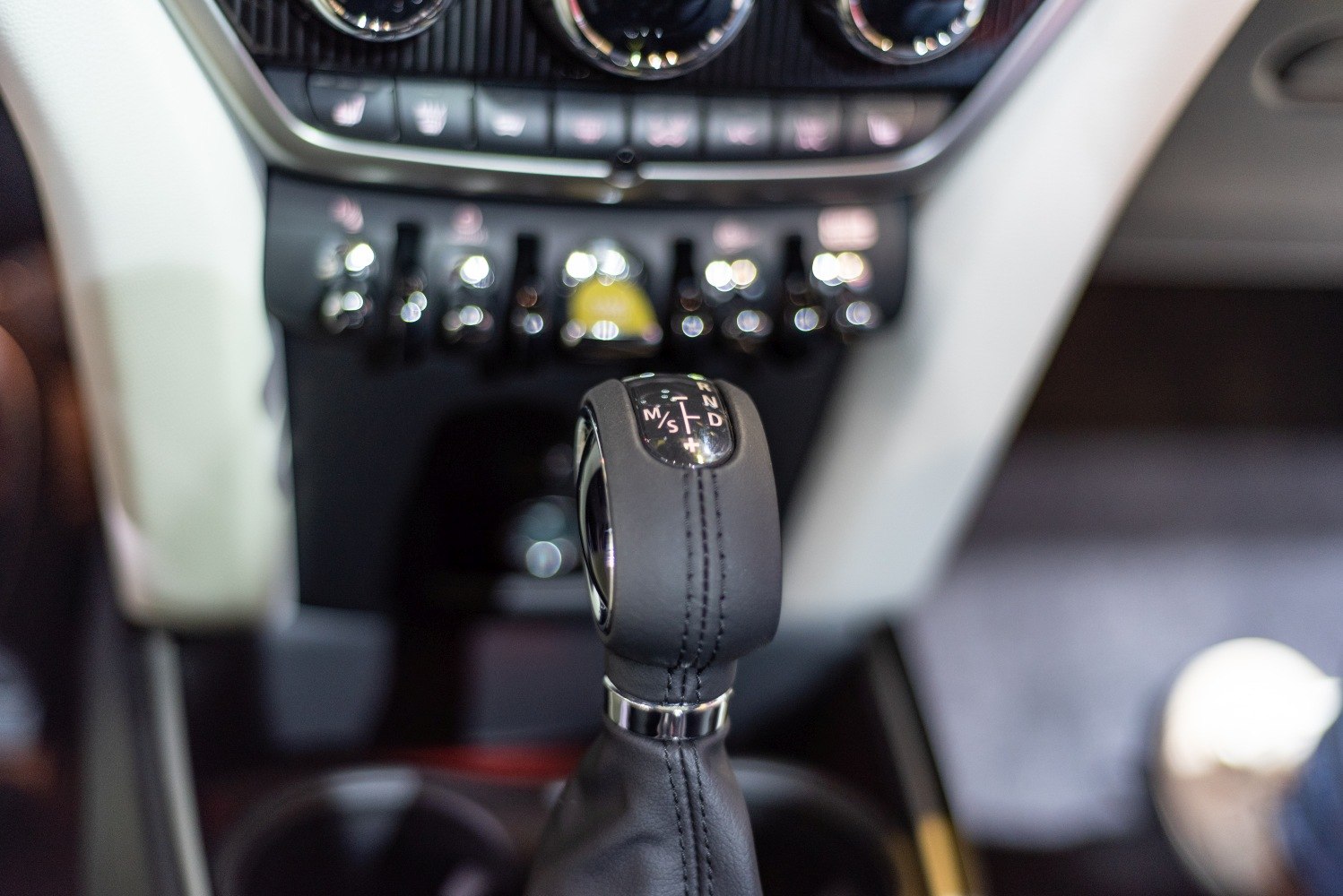 Close-up of a gear shift lever and control switches in car interior