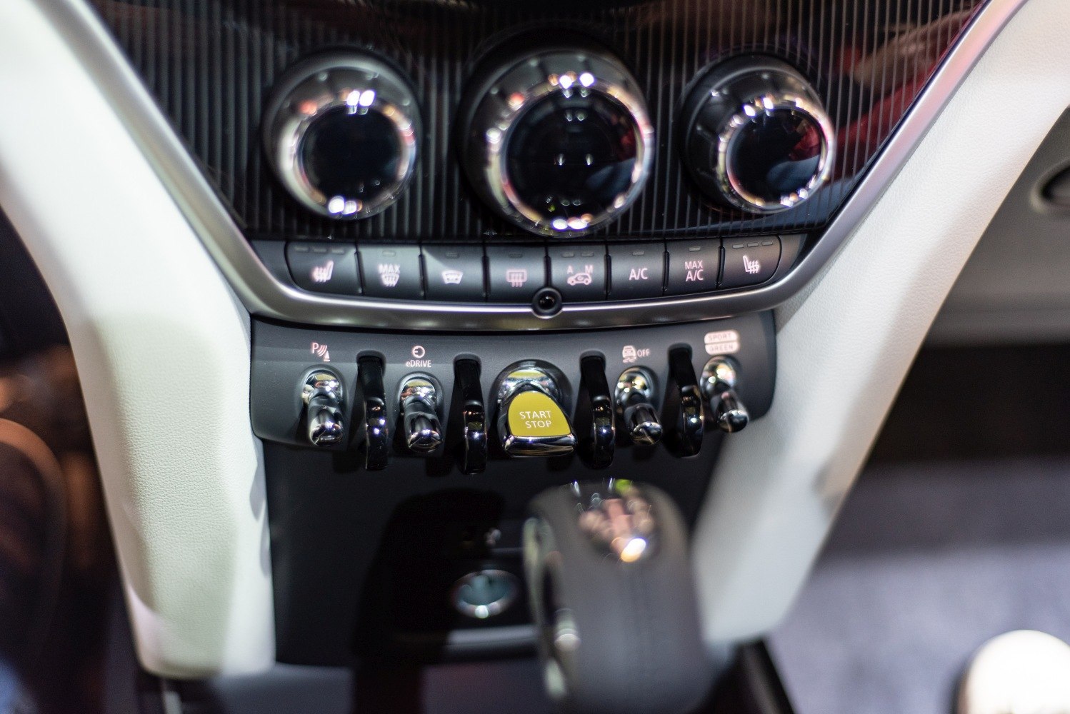 Toggle switches and round climate control dials on car interior control panel