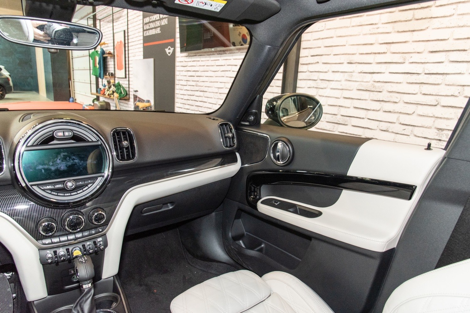 Modern car dashboard and door panel with detailed controls and leather seating