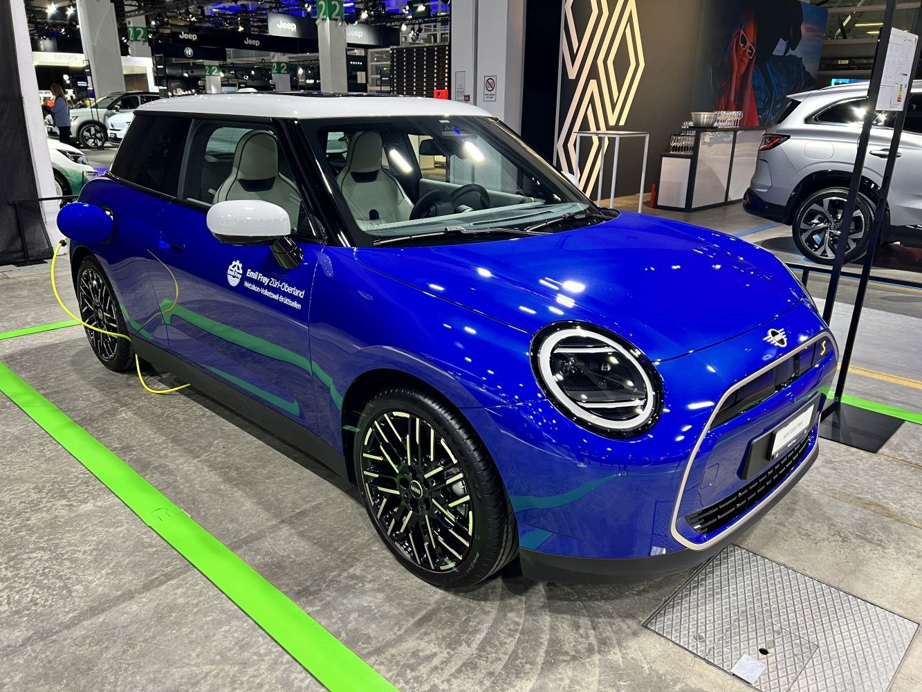 Compact electric vehicle with blue body and electric charging