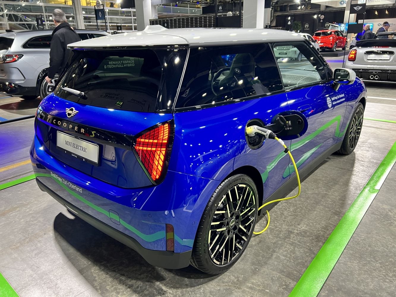 Mini Electric in blue charging with detailed rear design and large alloy wheels
