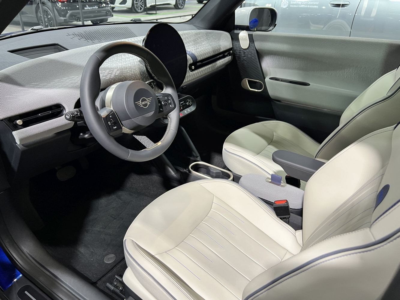 Modern steering wheel and stylish front seats in car interior