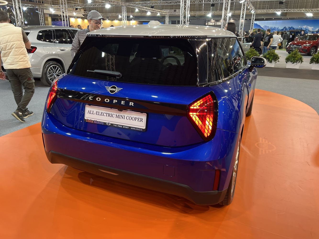 Rear view of blue electric hatchback with unique triangular taillights