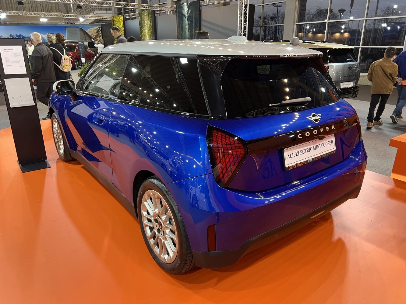Rear side view of blue electric hatchback with unique taillights