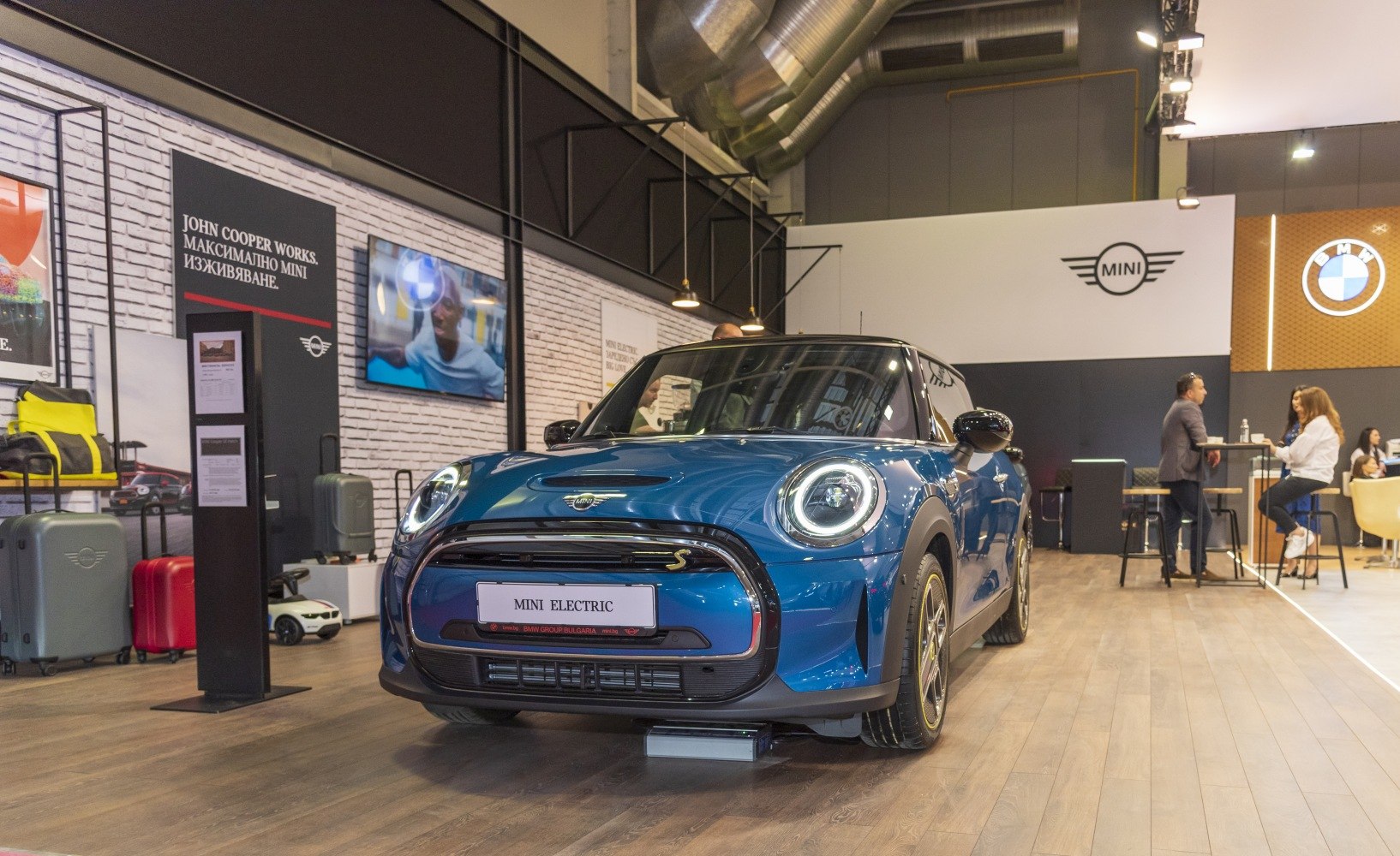 Front view with modern round LED headlights and showroom setting