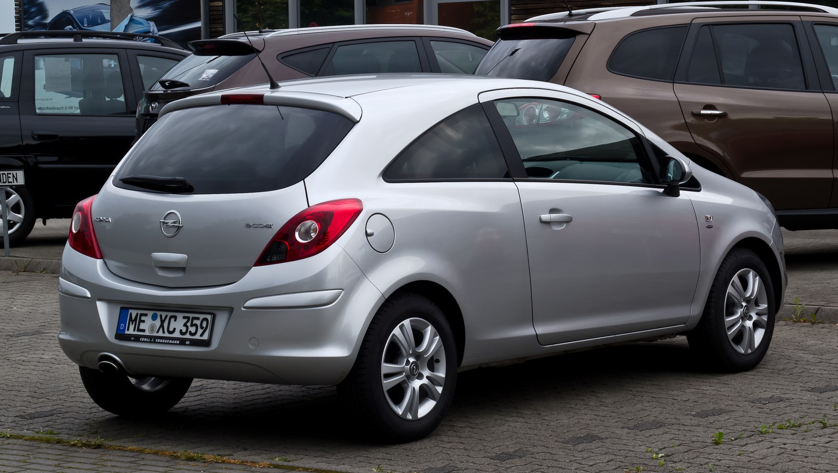 Silver 3-door hatchback with rear spoiler and distinctive taillights