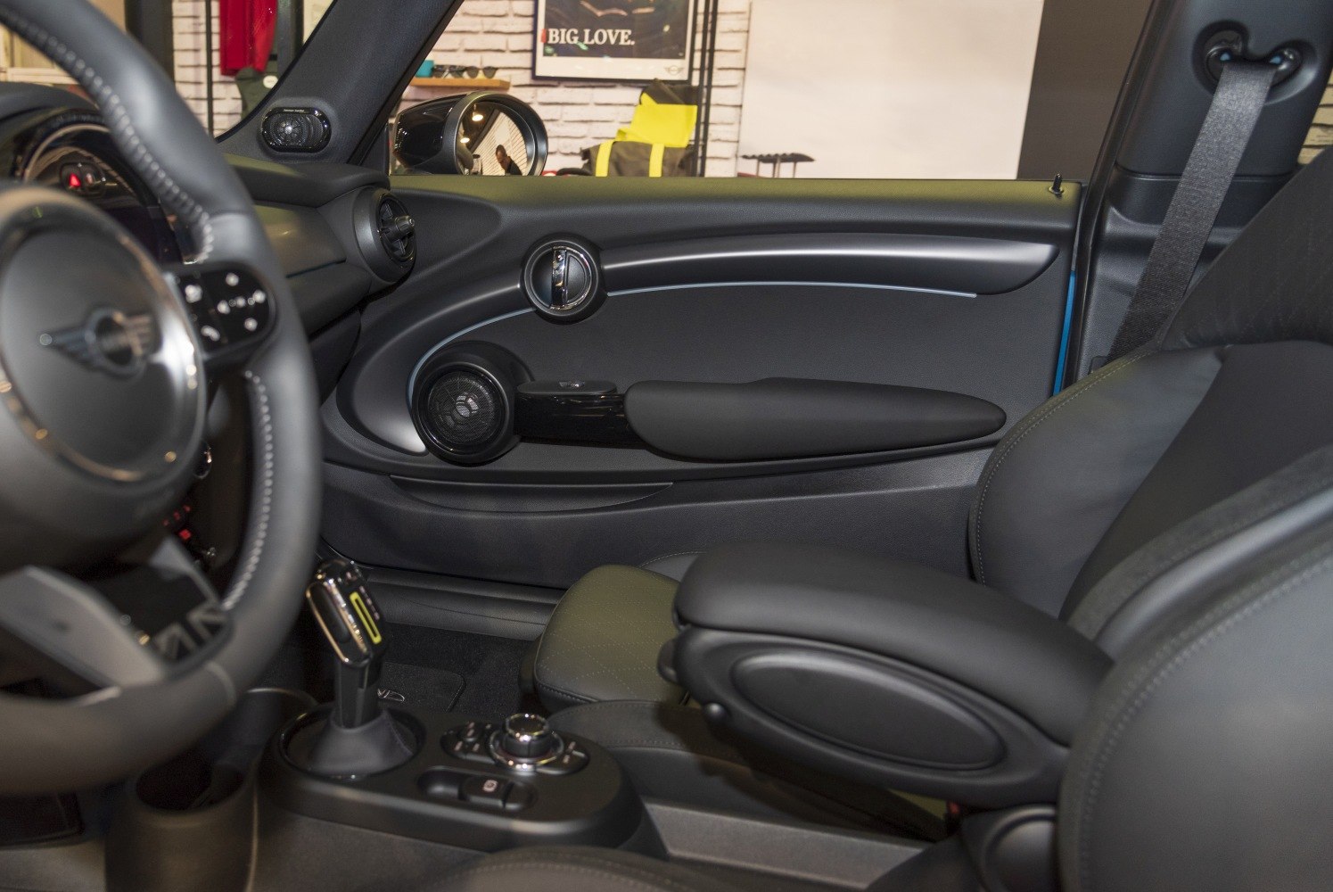 Door panel with speaker, armrest, gear selector, and center console controls