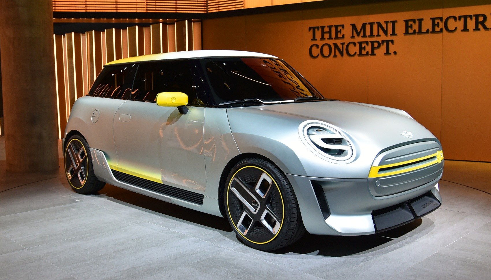 Silver electric vehicle with yellow accents and distinctive modern alloy wheels