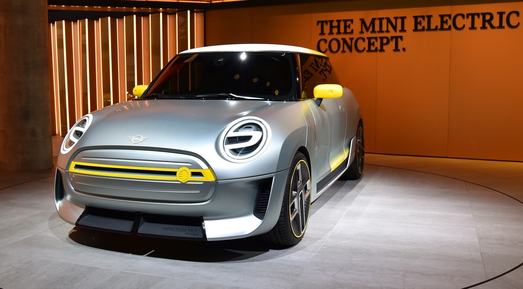 Futuristic LED ring headlights and closed grille with yellow accents