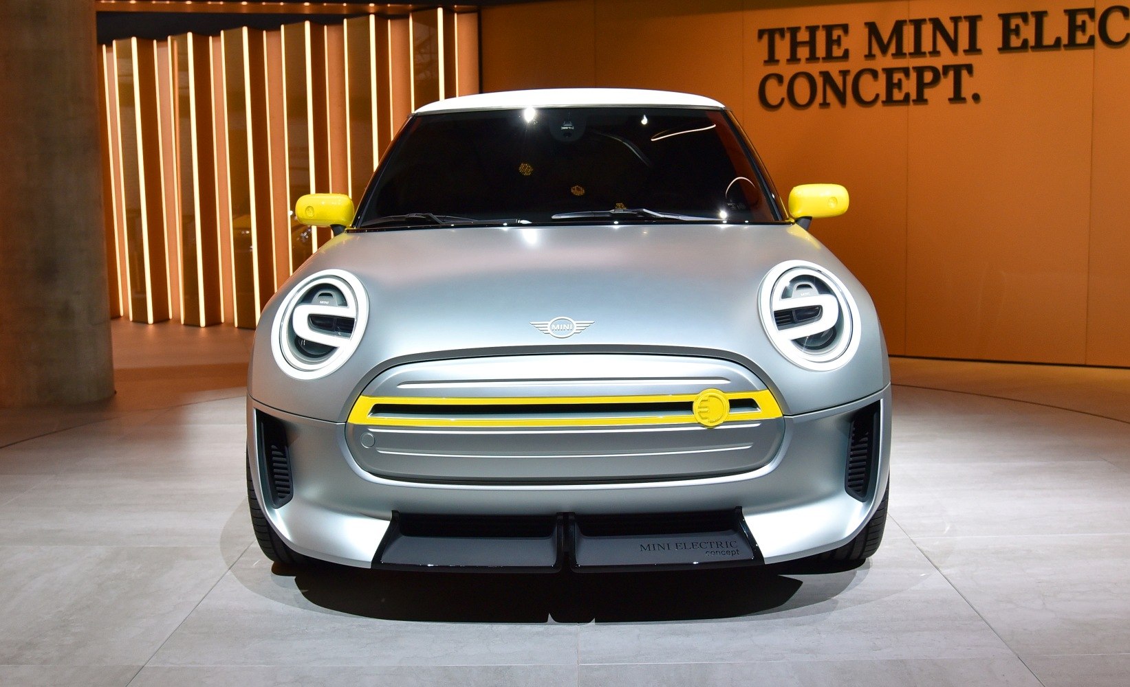 Front view of electric car with LED headlights and yellow accents