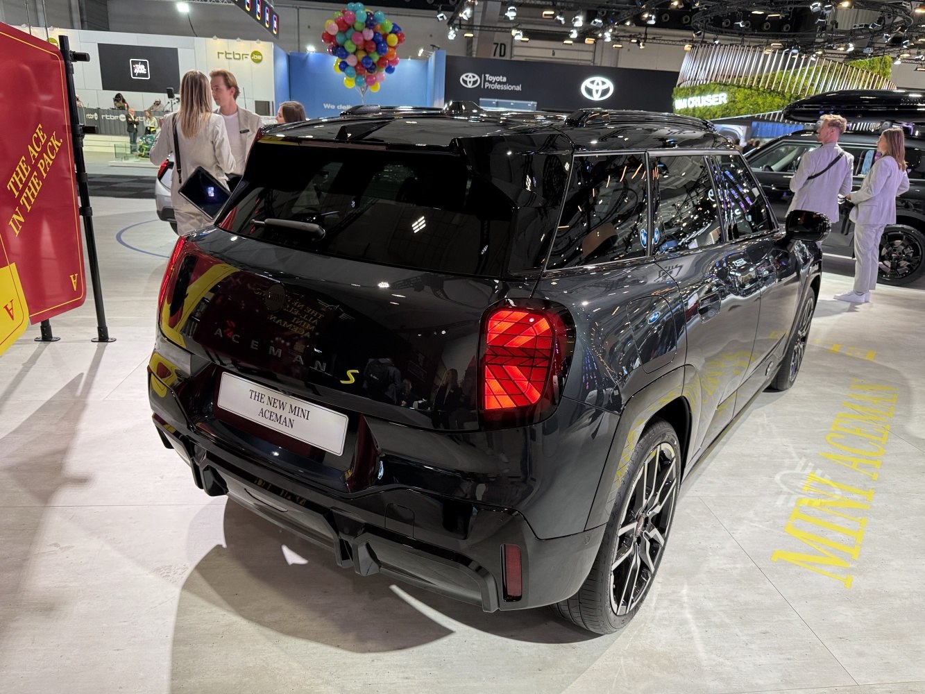 Rear view of a compact SUV with unique taillights, roof rails, and sporty alloy wheels