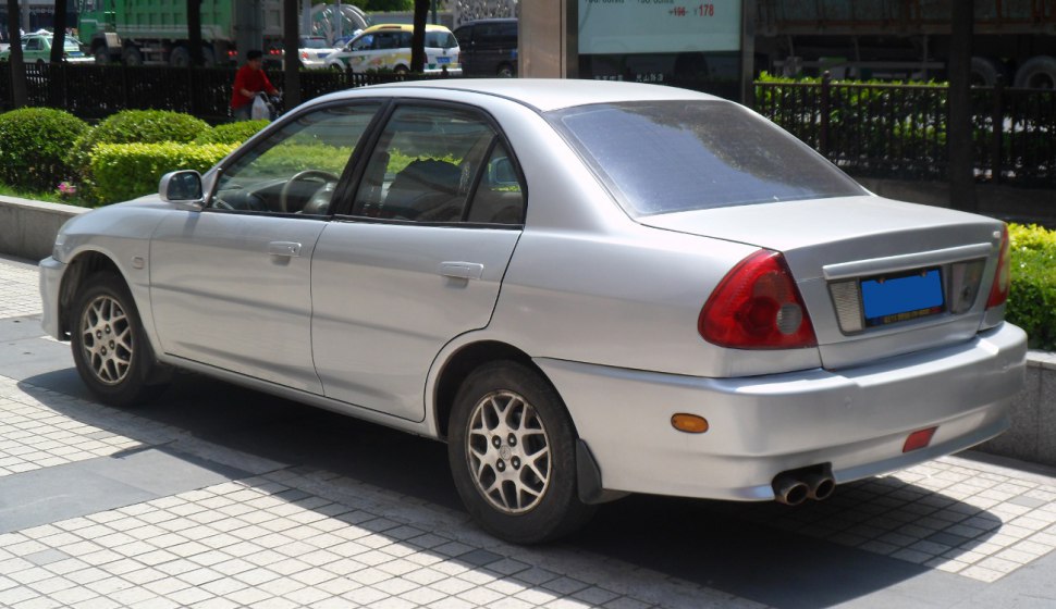 Silver 4-door sedan with rear dual exhaust and alloy wheels