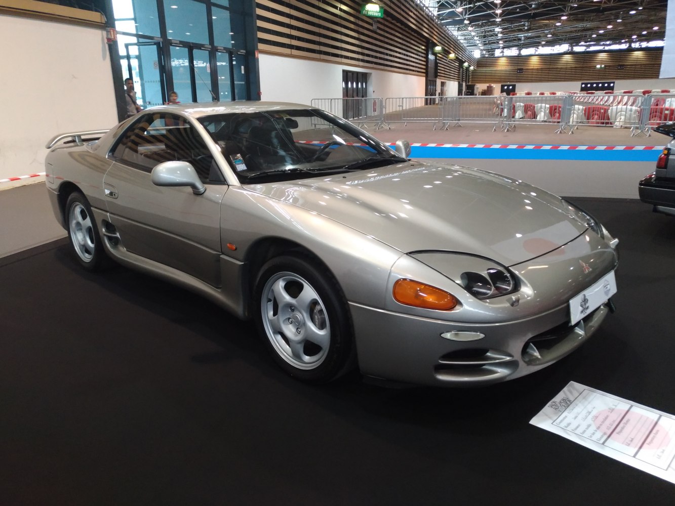 Silver sports coupe with distinctive dual-headlight pods and aerodynamic body