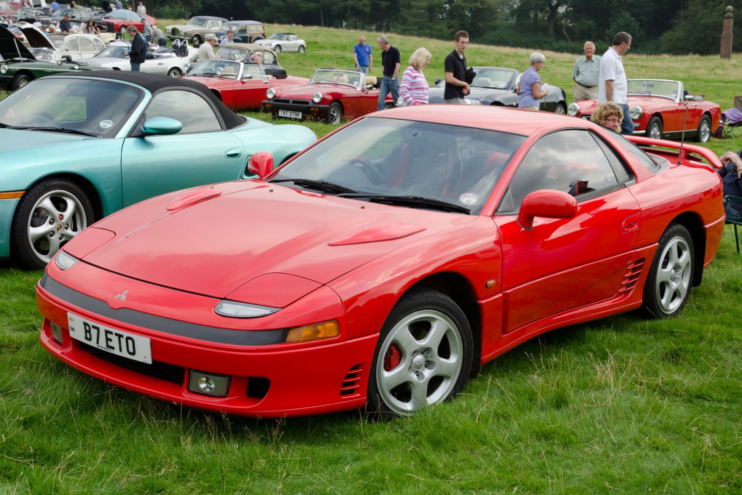 Red sports coupe with pop-up headlights and aerodynamic styling