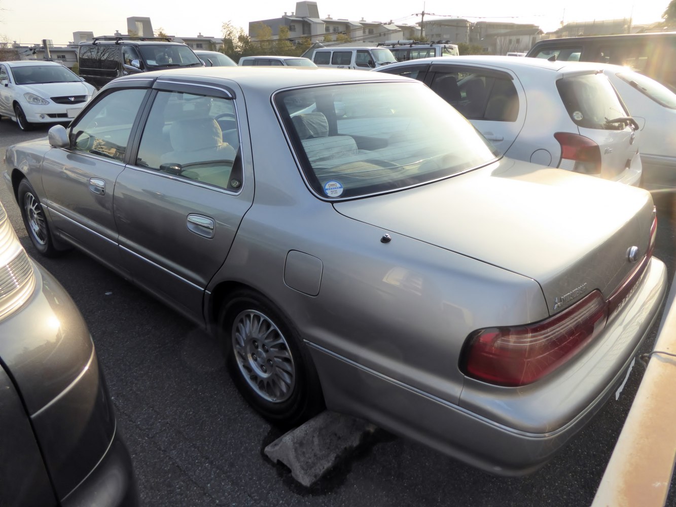 Rear and side view of classic 1990s sedan with alloy wheels