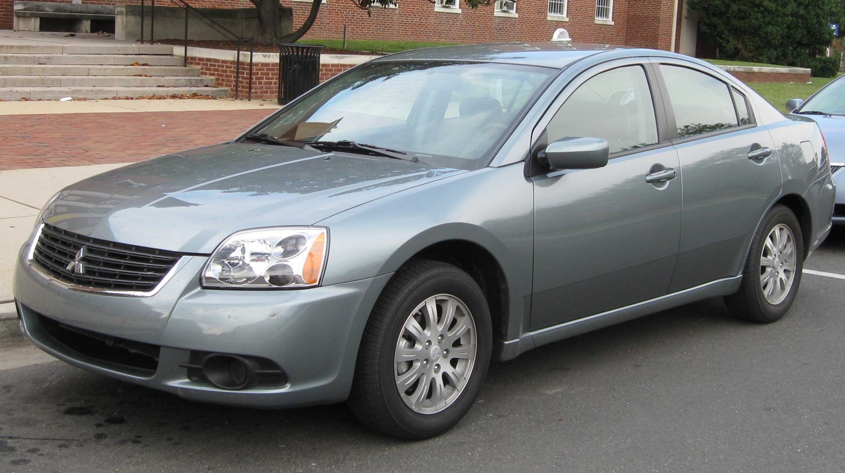 Front-side exterior view of a mid-size sedan with clear headlight and grille.