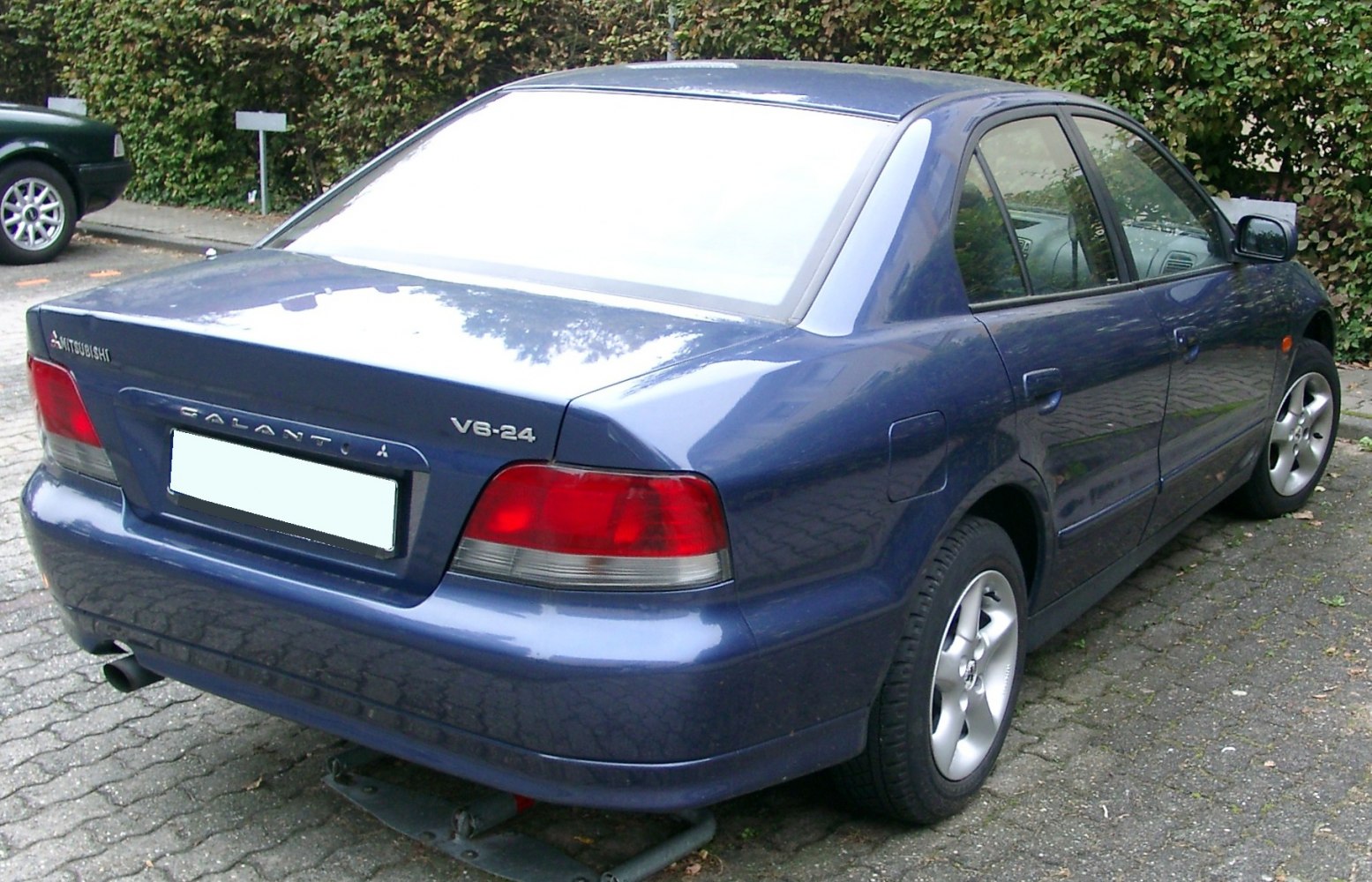 Rear three-quarter view of mid-1990s sedan with alloy wheels and taillights
