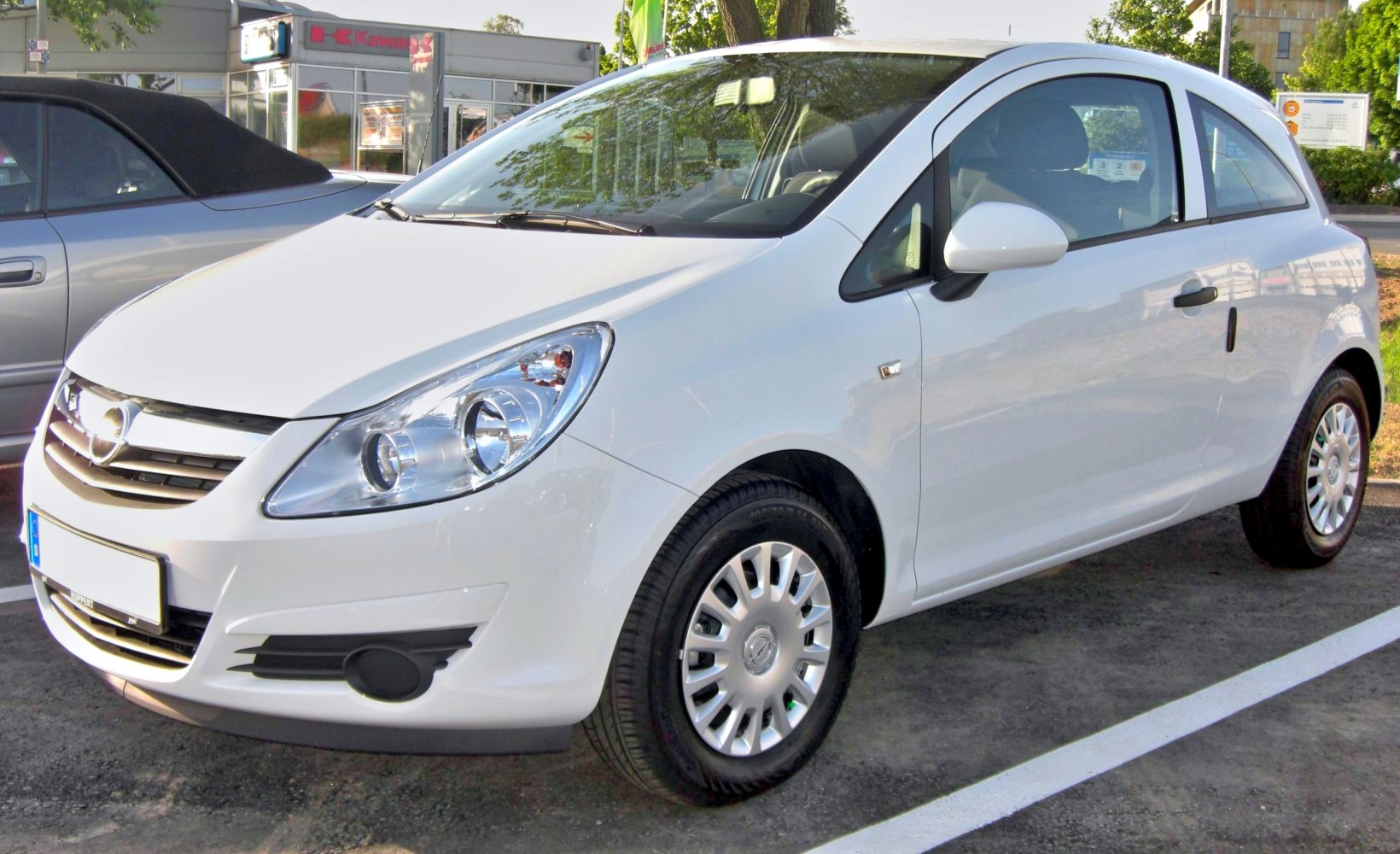 Front side view of compact 3-door hatchback with distinct headlights