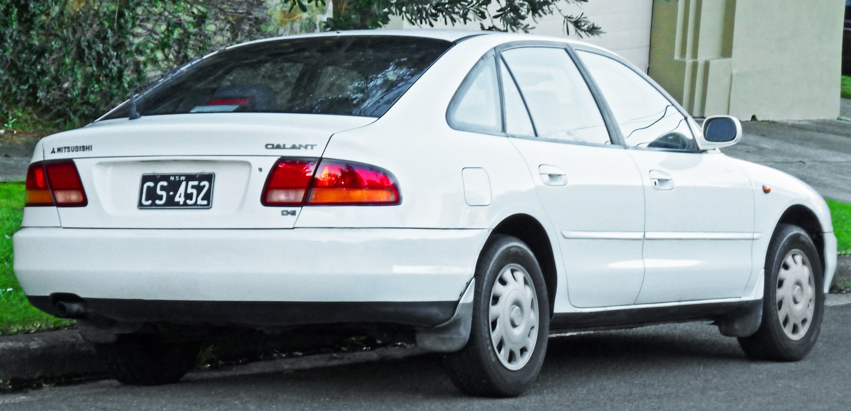 Rear and side angle of white hatchback with distinctive taillights
