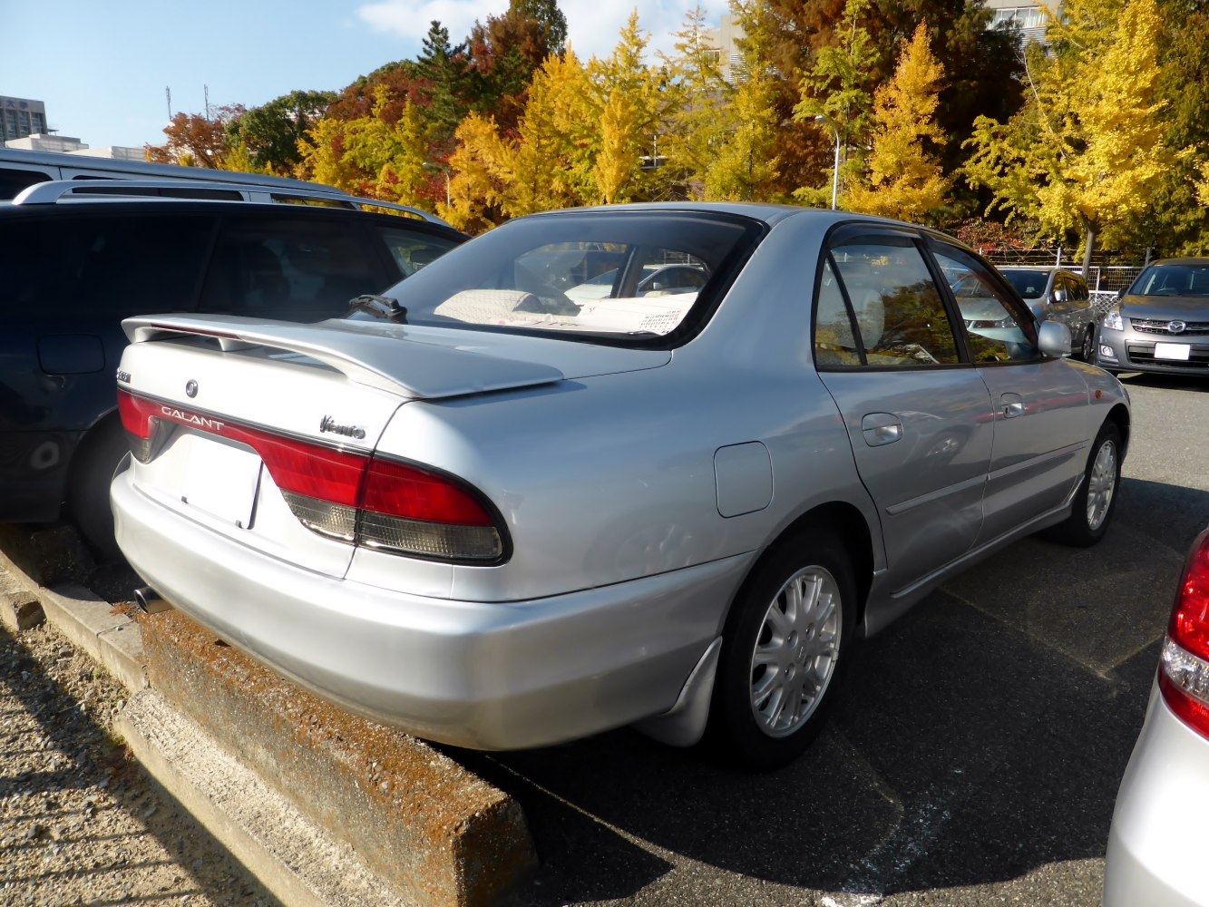 Silver sedan rear with spoiler and distinctive taillights