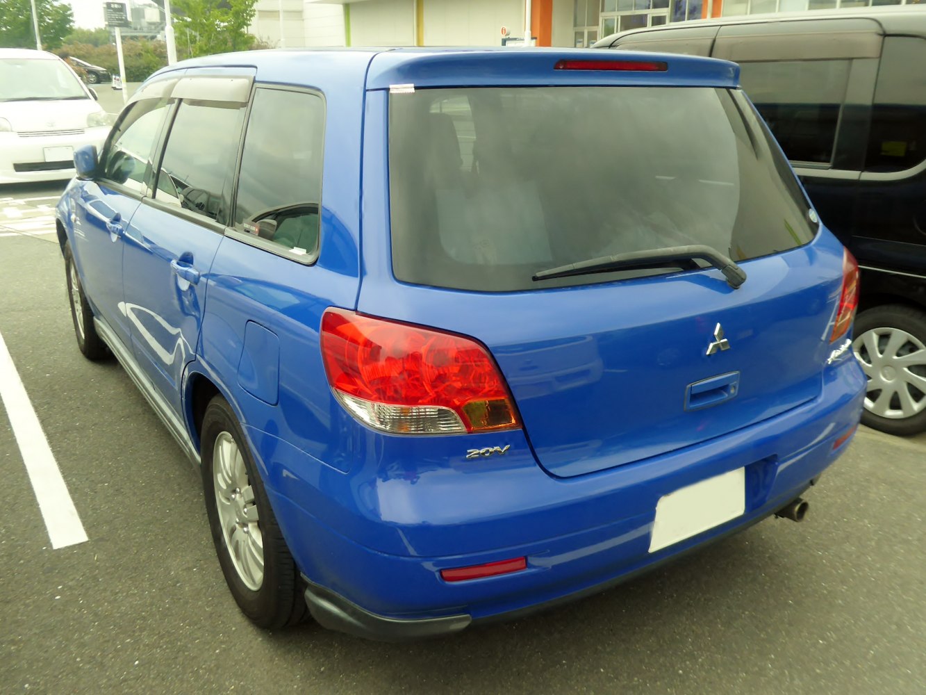 Rear view of blue SUV with rear windshield wiper and distinct taillights
