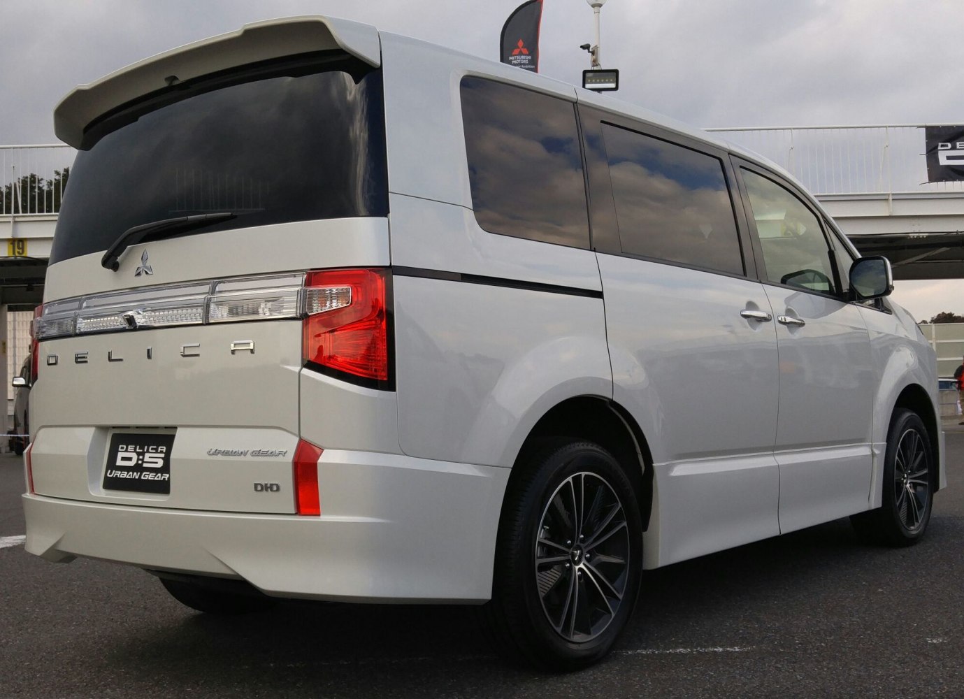 Rear view of a modern minivan with alloy wheels and dark tinted windows
