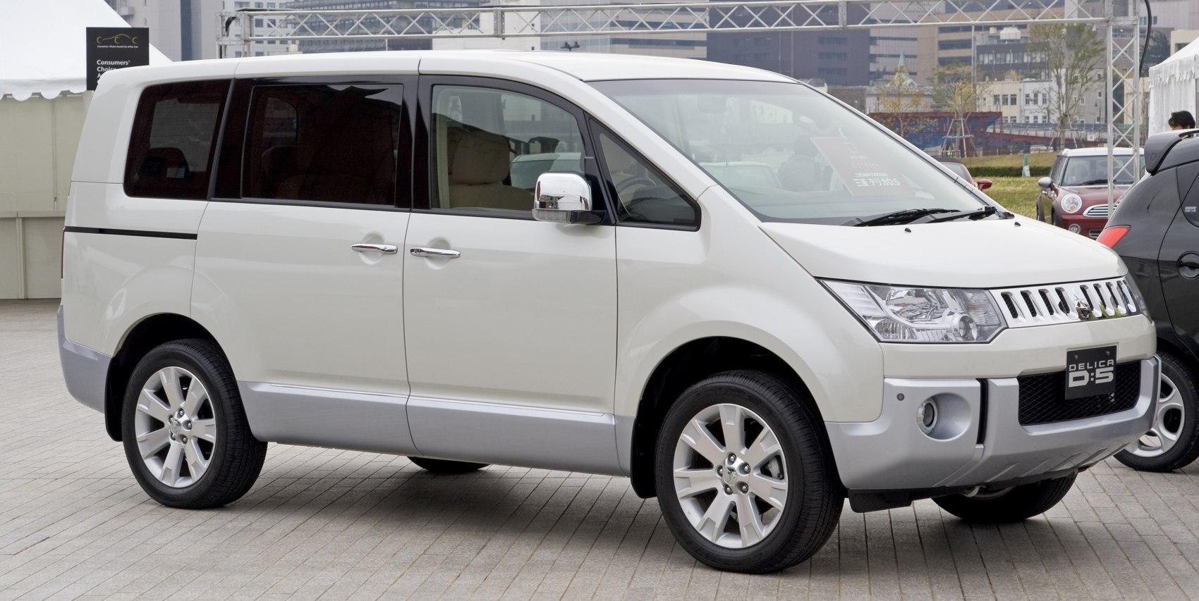 White minivan front-side view with alloy wheels