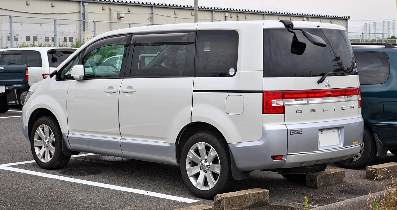 Rear and side profile of a minivan with sliding doors and distinct tail lights