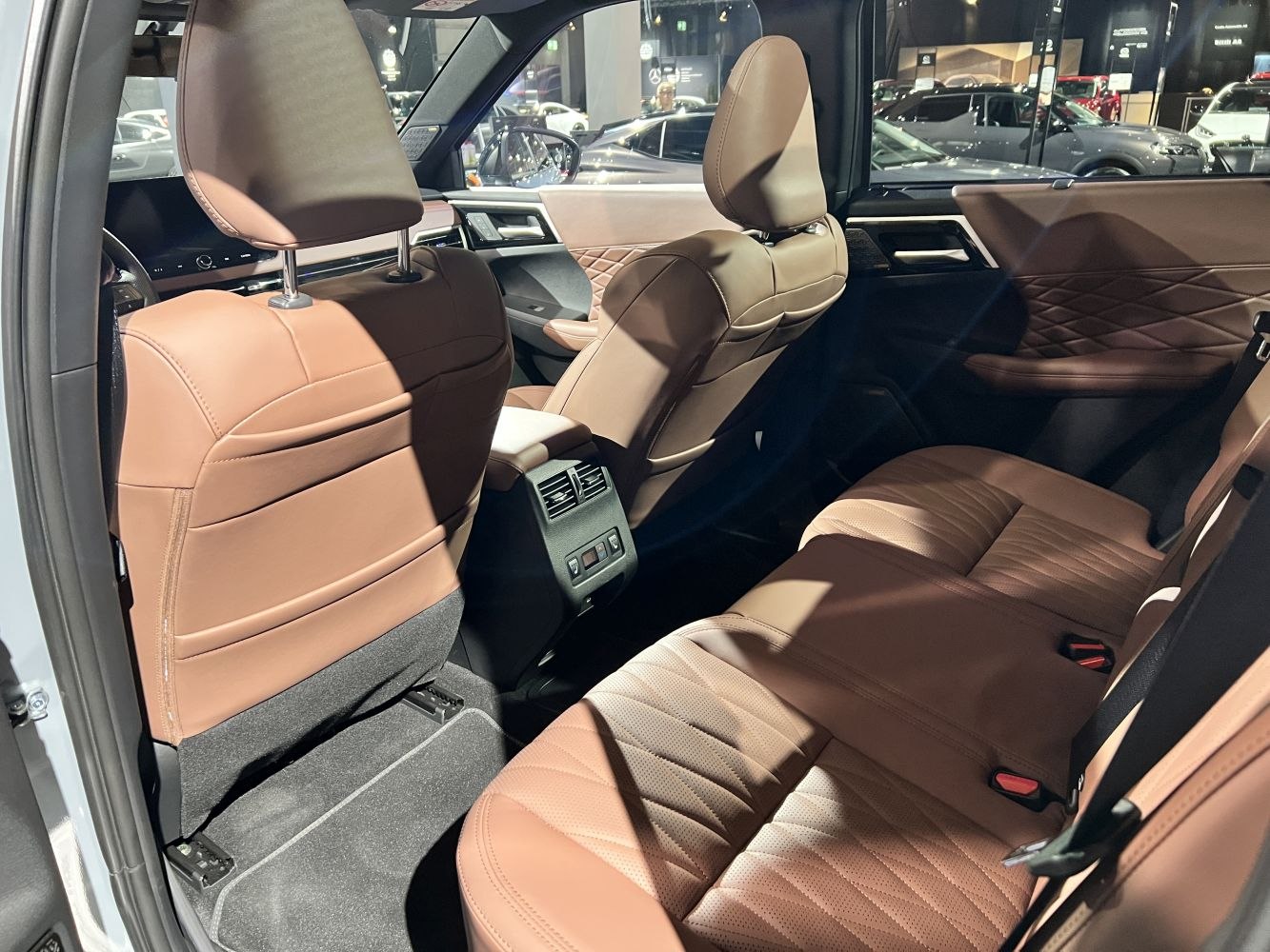 Brown leather rear seats with rear air vents and detailed door panels