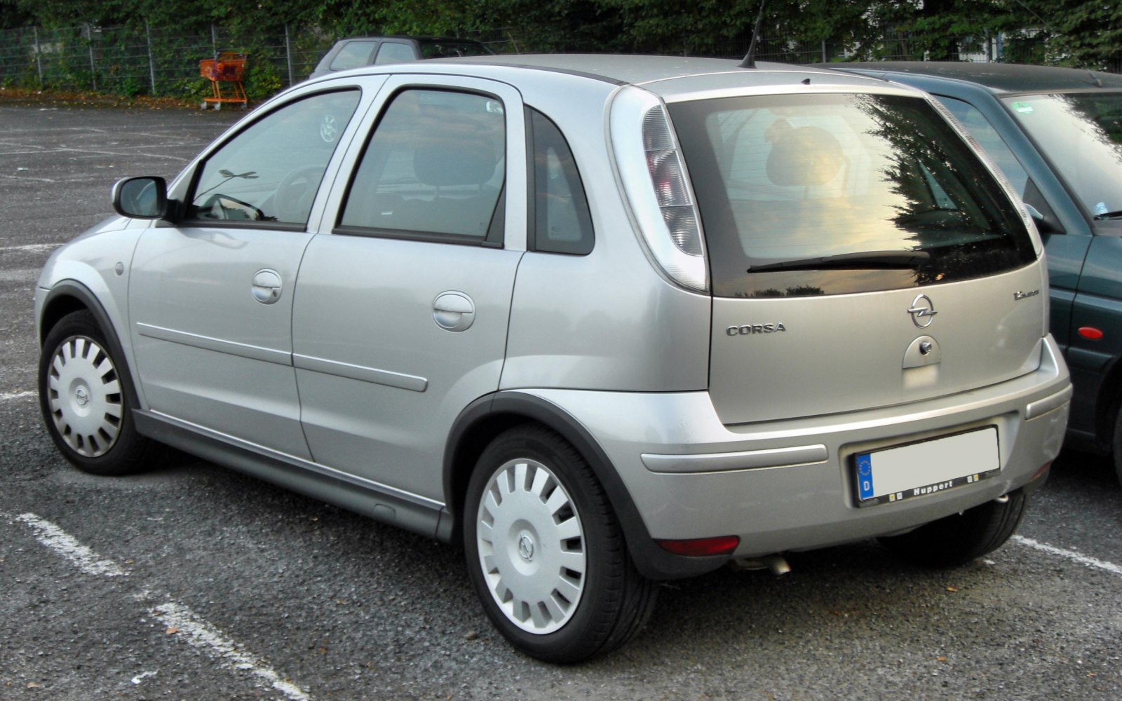 Silver compact hatchback with rear side view and tall vertical tail lights
