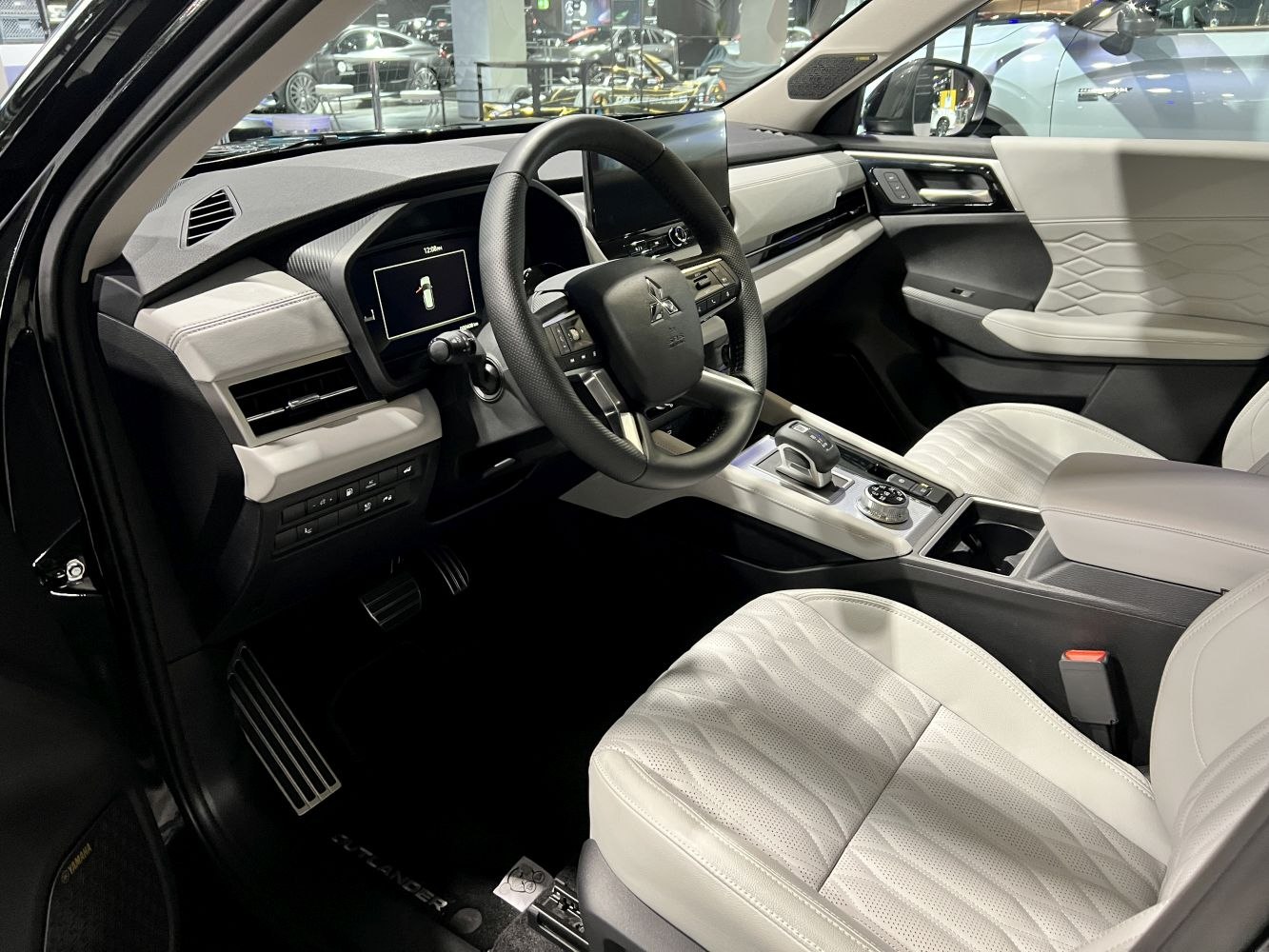Modern car interior with digital displays and premium white seats