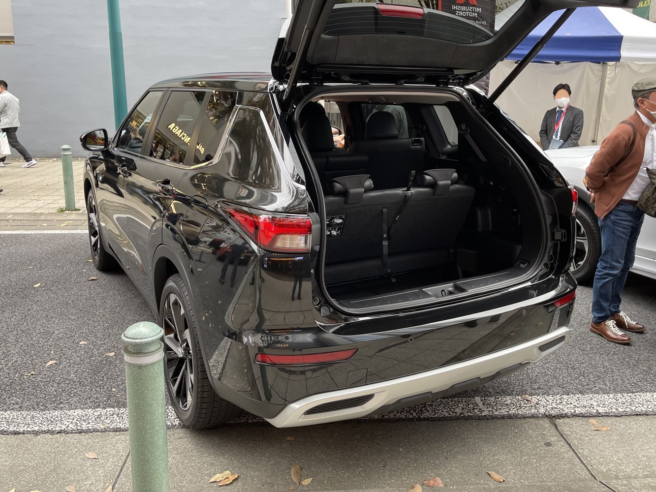 Open rear tailgate and spacious cargo area of a black SUV