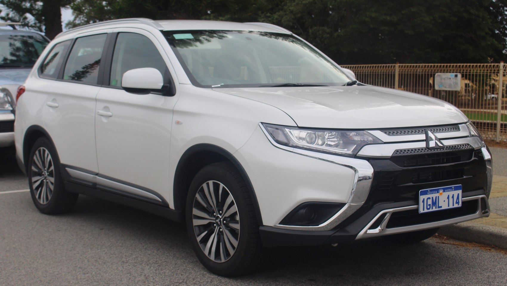 White SUV front and side view with distinctive grille and alloy wheels