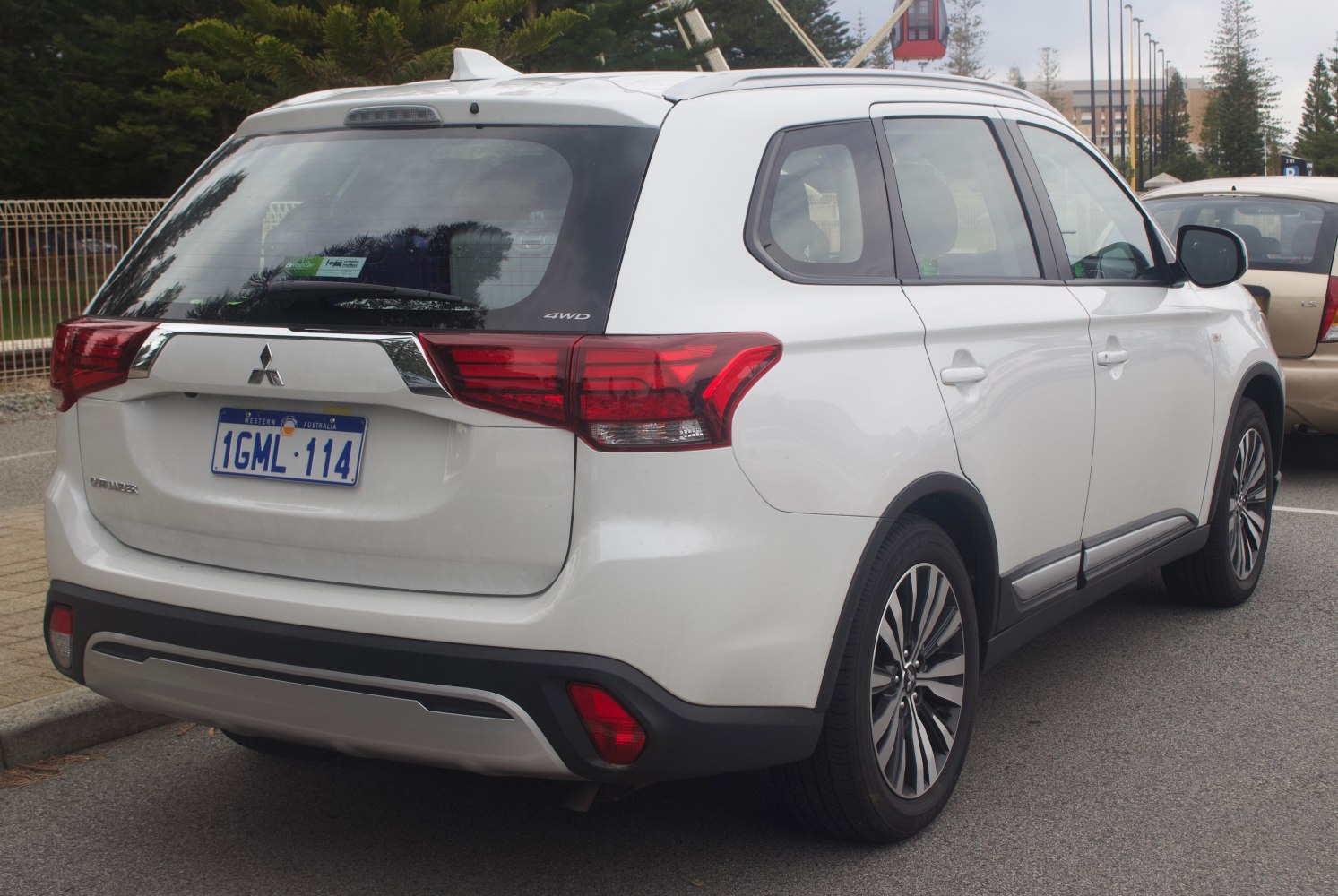 Rear side view with AWD badge and taillights of a white SUV