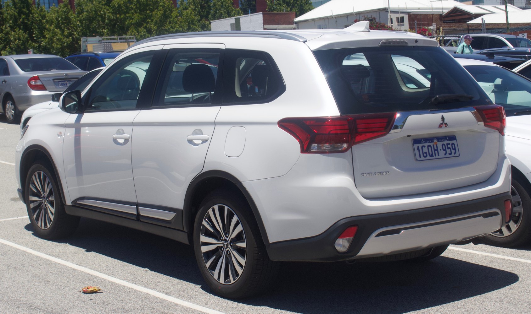 Rear and side view of a white mid-size SUV with alloy wheels
