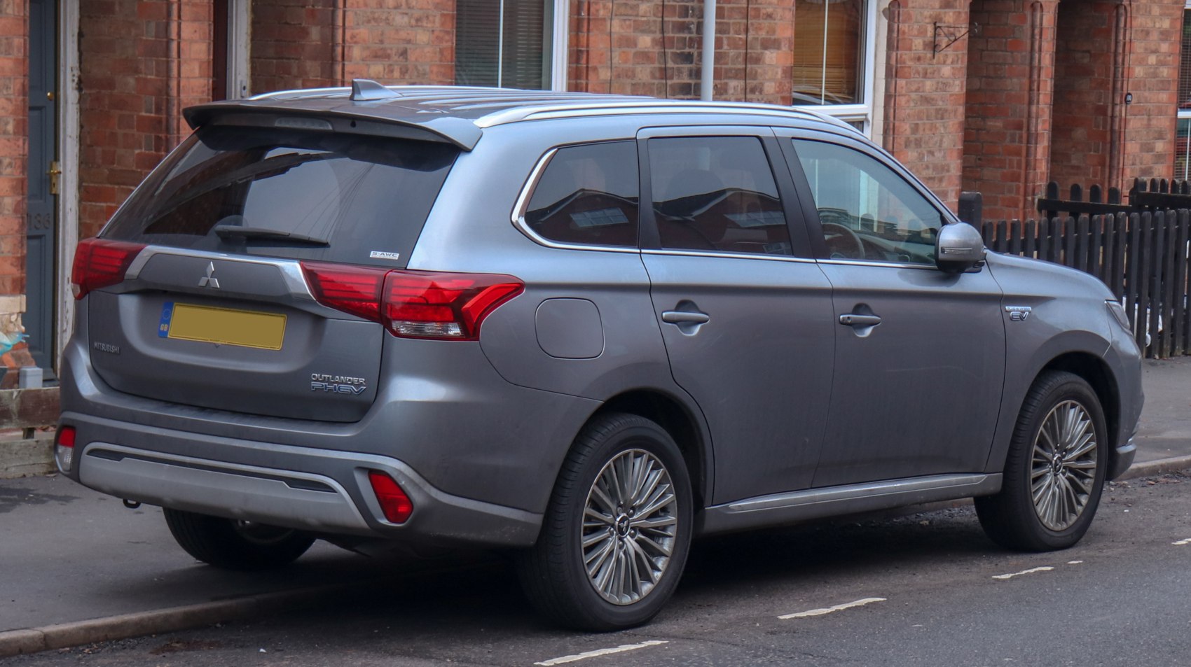 Rear side view of grey Mitsubishi PHEV SUV with alloy wheels