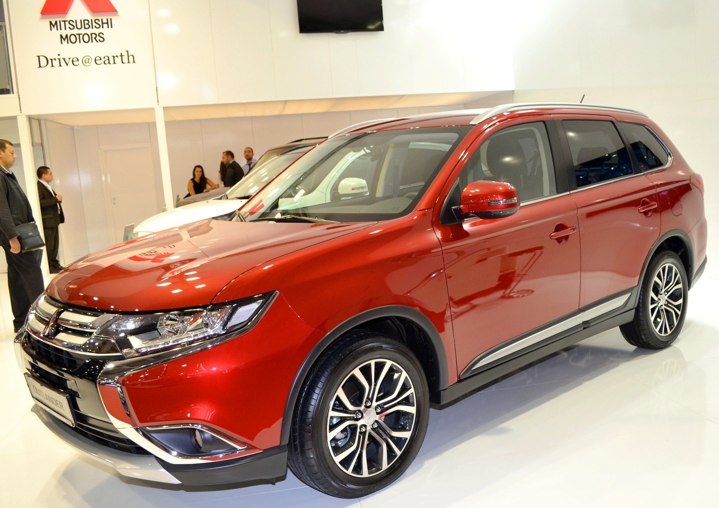 Red SUV front and side view with elegant grille and alloy wheels