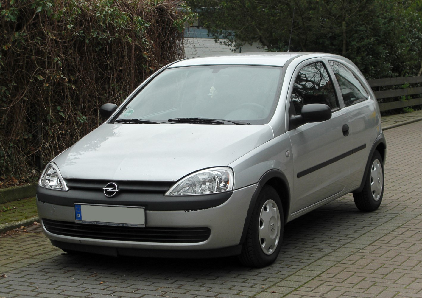 Compact silver hatchback with black trim and distinctive headlights