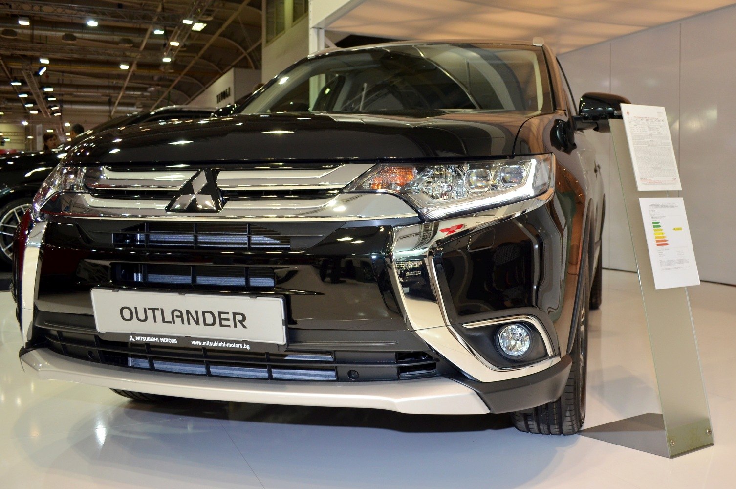 Front end featuring chrome grille and sleek headlights