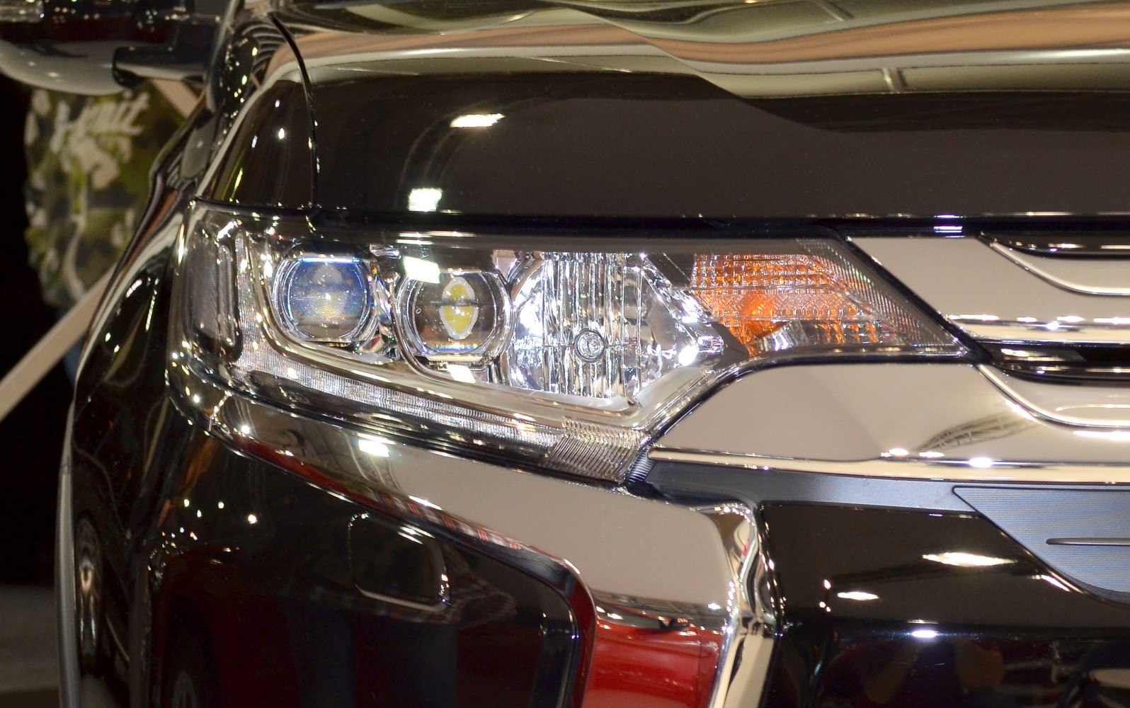 Close-up of front headlight and chrome grille