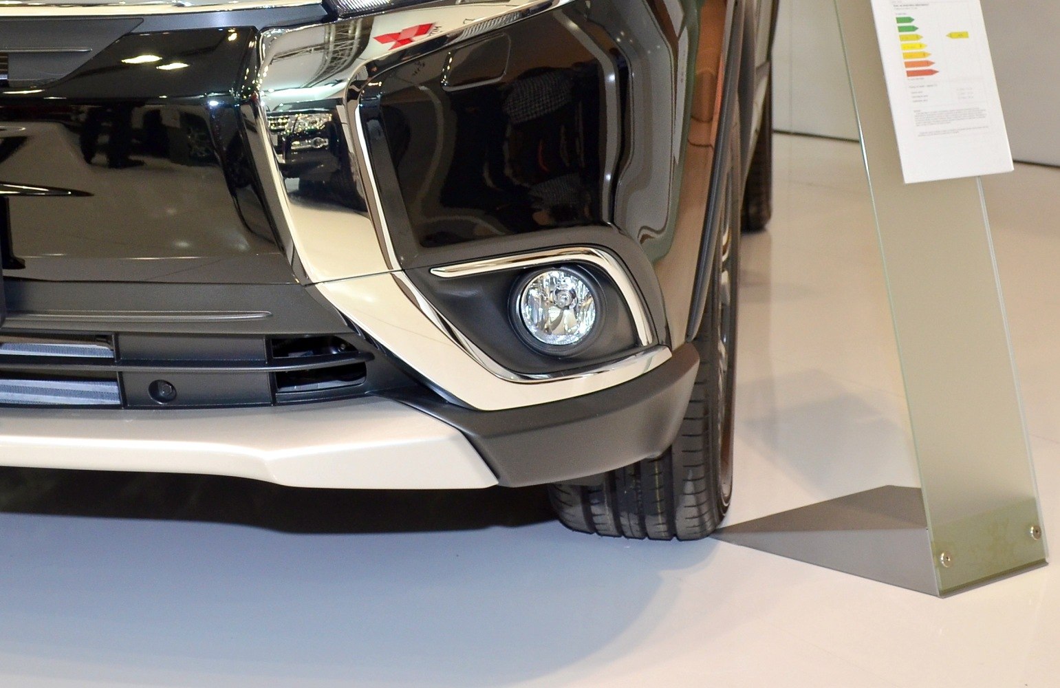 Front fog light and bumper design detail with polished trim and reflective surfaces