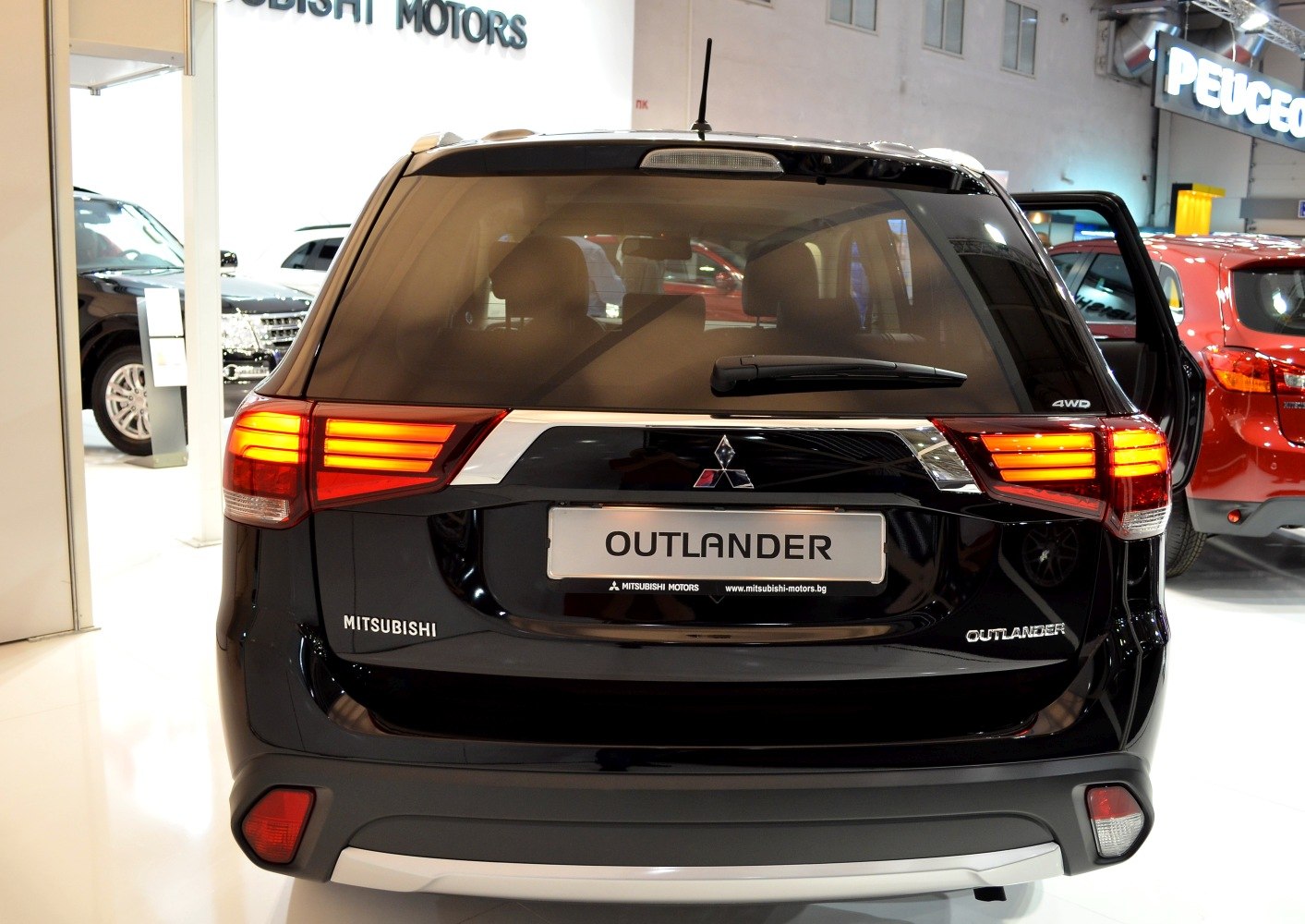 Rear view with illuminated tail lights and 4WD badge