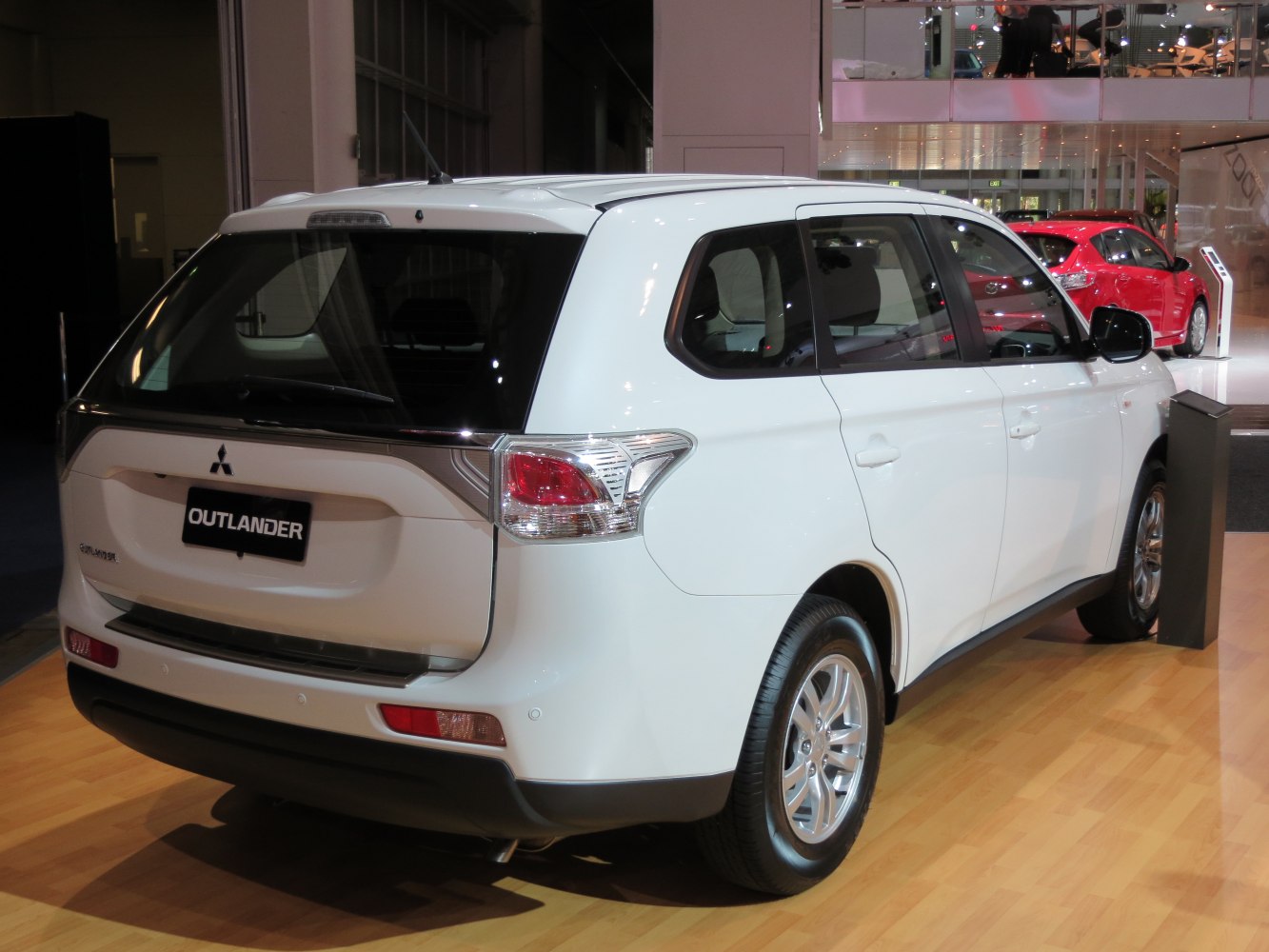Rear view showing tail lights and rear window design of white SUV.