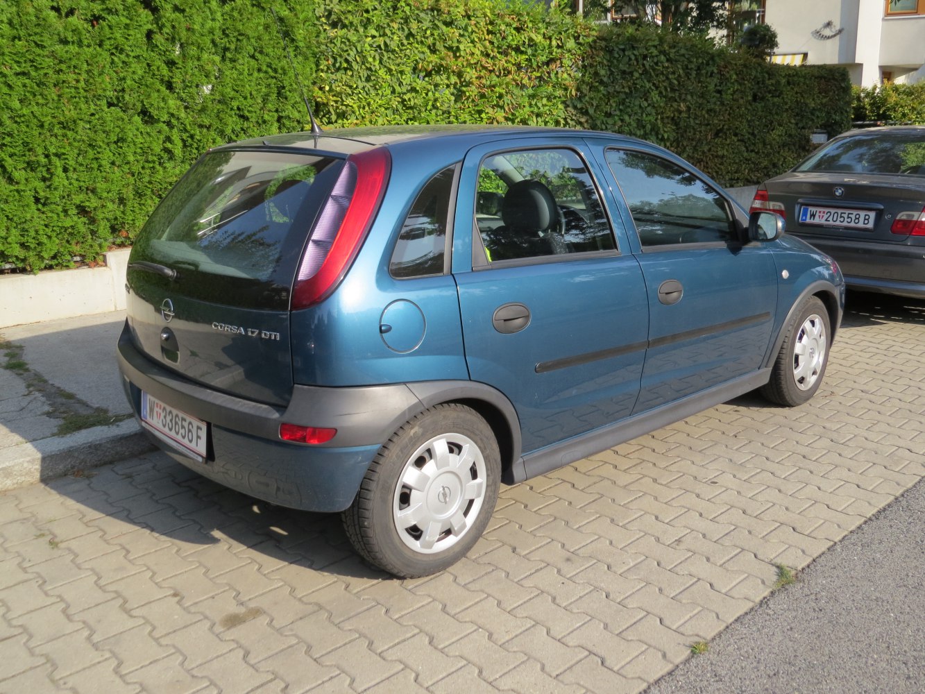 Rear-side view of compact hatchback with distinct taillights and wheel covers