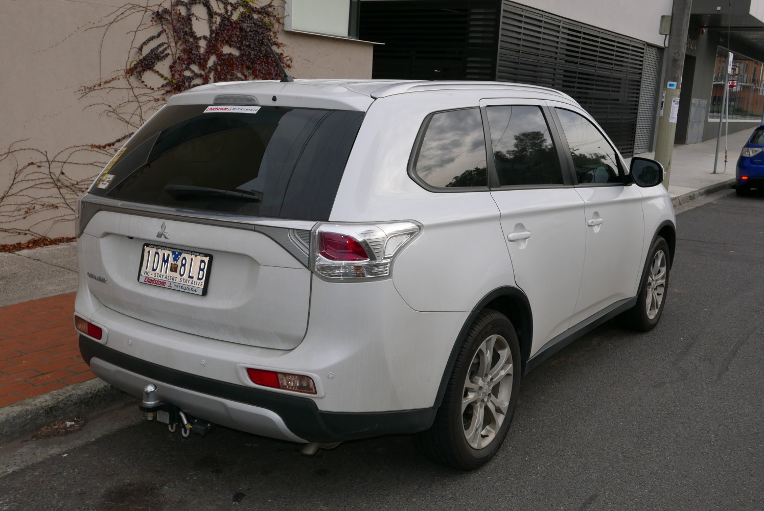 Rear view of SUV with tow hitch and tinted windows