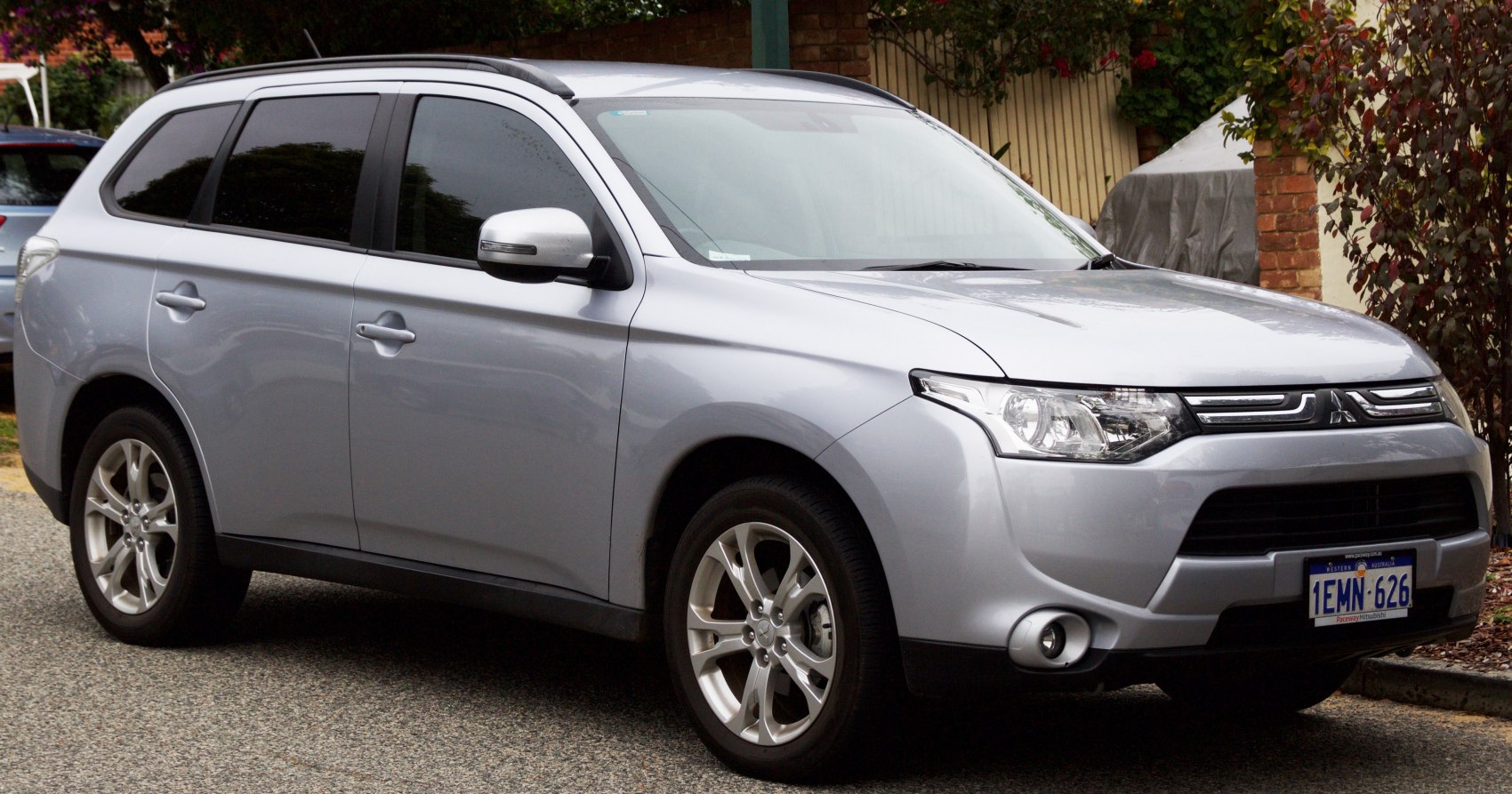 Silver mid-size SUV with alloy wheels and panoramic windows in street setting